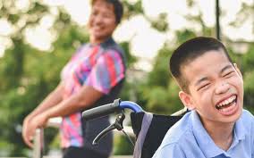 Two young friends laughing together outdoors